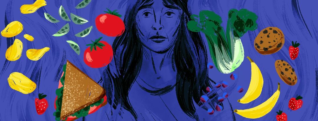 A distressed looking woman in a dark space stands behind floating colorful food